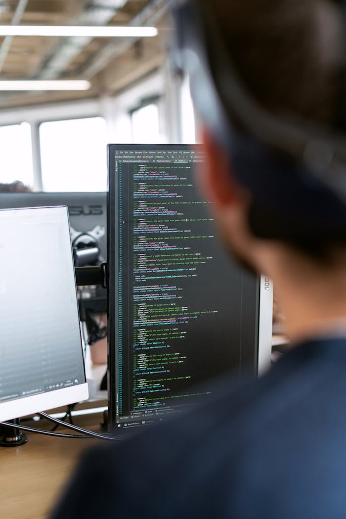 Man in Black Shirt Sitting in Front of Computer